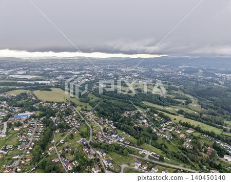 Aerial view of suburban landscape under low storm clouds Aerial view of suburban landscape under low storm clouds 140450140