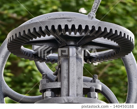 Close-up of weathered metal gear mechanism with handwheel Close-up of weathered metal gear mechanism with handwheel 140450188
