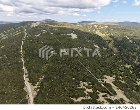 Aerial view of mountain ridge with winding trail and heather-covered slopes Aerial view of mountain ridge with winding trail and heather-covered slopes 140450262