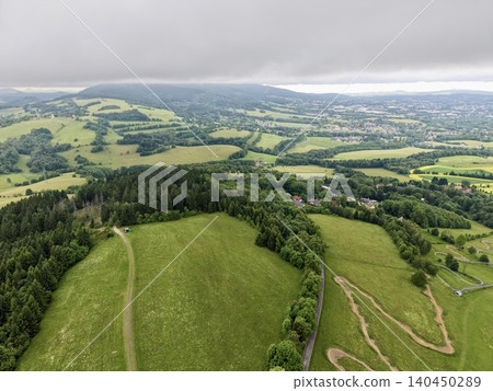 Aerial view of rolling green countryside under low clouds 140450289