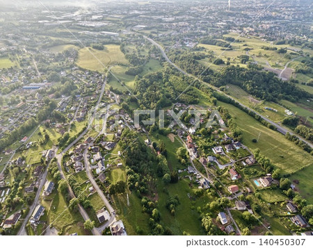 Aerial view of suburban neighborhood and rolling green countryside Aerial view of suburban neighborhood and rolling green countryside 140450307