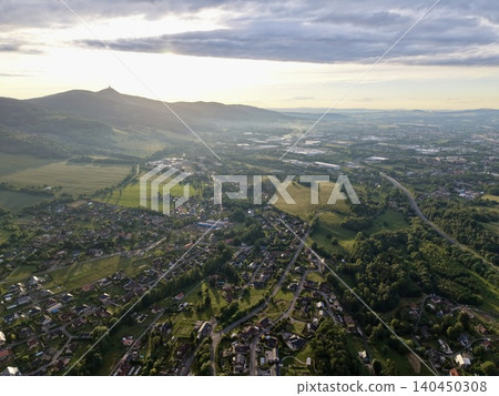 Aerial view of a rural town with rolling hills and evening light Aerial view of a rural town with rolling hills and evening light 140450308