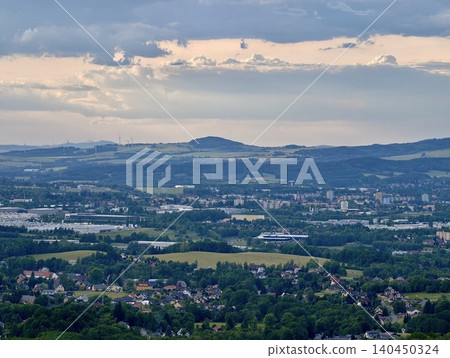 Panoramic view of a small town and rolling hills under a dramatic cloudy sky Panoramic view of a small town and rolling hills under a dramatic cloudy sky 140450324