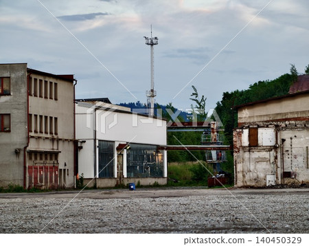 Abandoned industrial buildings with tall communication mast Abandoned industrial buildings with tall communication mast 140450329