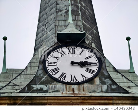 Antique clock face on weathered copper steeple with Roman numerals Antique clock face on weathered copper steeple with Roman numerals 140450348