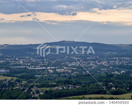 Panoramic city view beneath cloudy evening sky Panoramic city view beneath cloudy evening sky 140450503