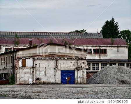 Abandoned industrial building with gravel pile Abandoned industrial building with gravel pile 140450505