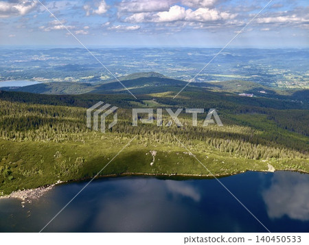 Panoramic mountain landscape with lake and distant valleys Panoramic mountain landscape with lake and distant valleys 140450533