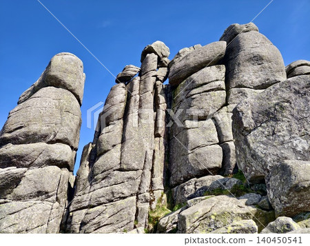 Towering granite rock formations beneath a clear blue sky Towering granite rock formations beneath a clear blue sky 140450541