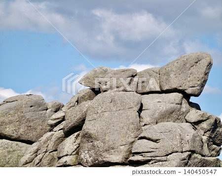Weathered granite boulders beneath a blue sky Weathered granite boulders beneath a blue sky 140450547