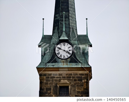 Historic clock tower with weathered copper spire Historic clock tower with weathered copper spire 140450565