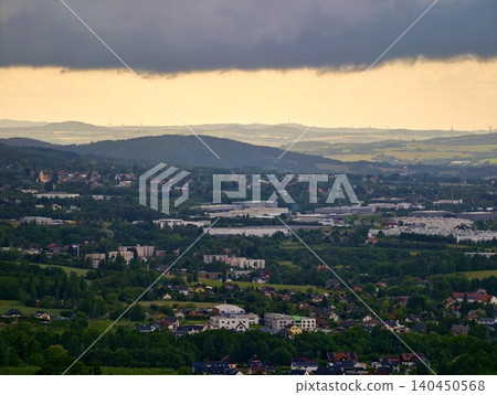 Dramatic storm clouds over a green valley town Dramatic storm clouds over a green valley town 140450568