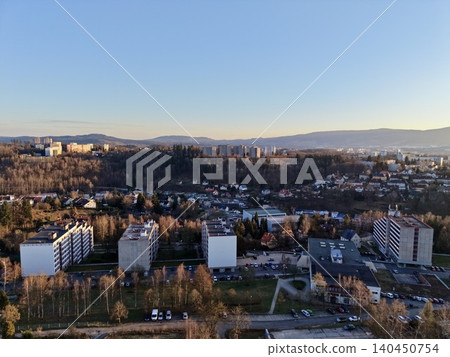 Peaceful Suburban Housing Complexes Illuminated By Gentle Evening Light With Surrounding Nature Peaceful Suburban Housing Complexes Illuminated By Gentle Evening Light With Surrounding Nature 140450754