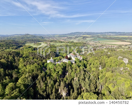 Secluded Village Perched On Hill Encased By Dense Green Woods Showcasing Traditional Rural Beauty Secluded Village Perched On Hill Encased By Dense Green Woods Showcasing Traditional Rural Beauty 140450782