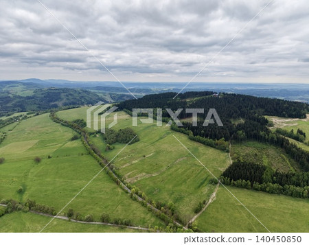 Pastoral Scene With Hills And Hedges. Overcast Sky Over Rolling Pastures And Rural Farmland Landscape Pastoral Scene With Hills And Hedges. Overcast Sky Over Rolling Pastures And Rural Farmland Landscape 140450850