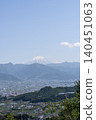 Mount Fuji with its remaining snow and the cityscape of the Kofu Basin as seen from Yamanashi in early summer. 140451063