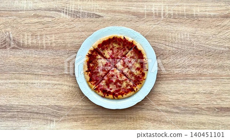A Delicious Pizza with Various Toppings Spread Out on a Rustic Wooden Table Surface A Delicious Pizza with Various Toppings Spread Out on a Rustic Wooden Table Surface 140451101