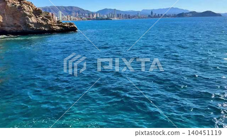 A stunning scenic coastal view showcasing clear blue waters under a radiant sky A stunning scenic coastal view showcasing clear blue waters under a radiant sky 140451119
