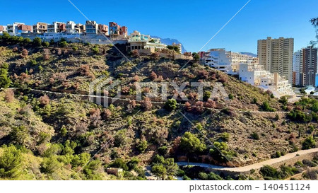 Experience a breathtaking coastal view that beautifully juxtaposes modern buildings with nature Experience a breathtaking coastal view that beautifully juxtaposes modern buildings with nature 140451124