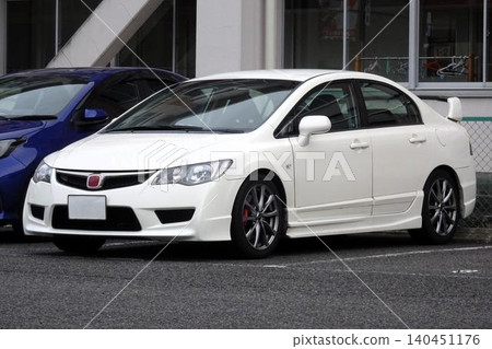 Passenger cars lined up in the parking lot 140451176
