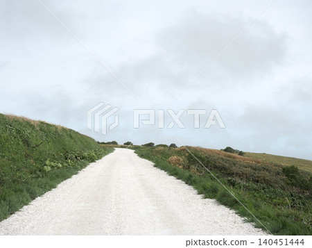 A white road on the Soya Hills under a light cloud cover A white road on the Soya Hills under a light cloud cover 140451444