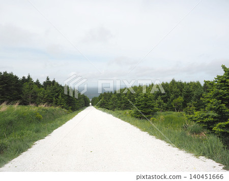 A white road on the Soya Hills under a light cloud cover A white road on the Soya Hills under a light cloud cover 140451666