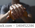 Middle age caucasian man hands holds cane closeup 140452286
