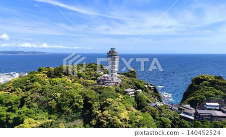 Aerial view of the Enoshima Sea Candle towering against the backdrop of the vast ocean. Aerial view of the Enoshima Sea Candle towering against the backdrop of the vast ocean. 140452524