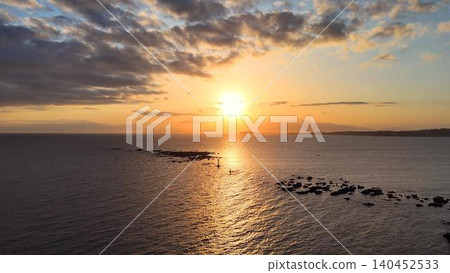 Aerial view of the sunset over the golden sea of Hayama and the torii gate of Najima. Aerial view of the sunset over the golden sea of Hayama and the torii gate of Najima. 140452533
