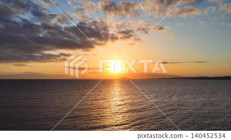 A breathtaking view of the sea bathed in golden hues at sunset, against a beautiful sky. A breathtaking view of the sea bathed in golden hues at sunset, against a beautiful sky. 140452534