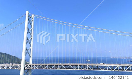 The main towers of the Akashi Kaikyo Bridge, boasting geometric beauty, against the blue sky. The main towers of the Akashi Kaikyo Bridge, boasting geometric beauty, against the blue sky. 140452541