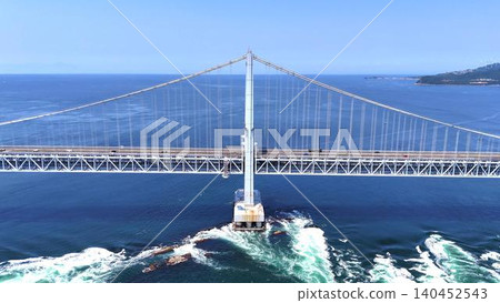 The massive main towers of the Great Naruto Bridge and the swirling Naruto Strait beneath them. The massive main towers of the Great Naruto Bridge and the swirling Naruto Strait beneath them. 140452543