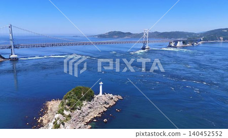 A stunning aerial view of Tobishima Island with its white lighthouse and the Great Naruto Bridge. 140452552