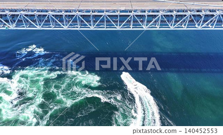 A breathtaking aerial view of the massive whirlpools and the shadow of the Great Naruto Bridge. A breathtaking aerial view of the massive whirlpools and the shadow of the Great Naruto Bridge. 140452553