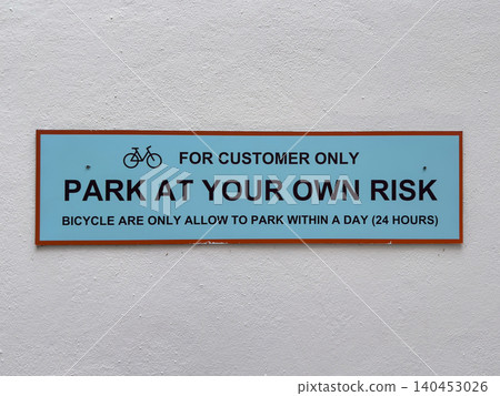 Customer parking sign with bicycle restrictions and risk disclaimer Customer parking sign with bicycle restrictions and risk disclaimer 140453026