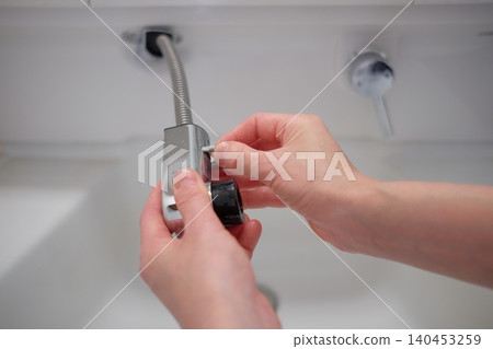 Removed shower head on the sink 140453259