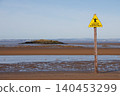 Yellow sinking mud warning sign on Weston-super-Mare beach at low tide 140453299