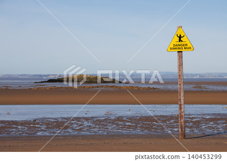 Yellow sinking mud warning sign on Weston-super-Mare beach at low tide Yellow sinking mud warning sign on Weston-super-Mare beach at low tide 140453299