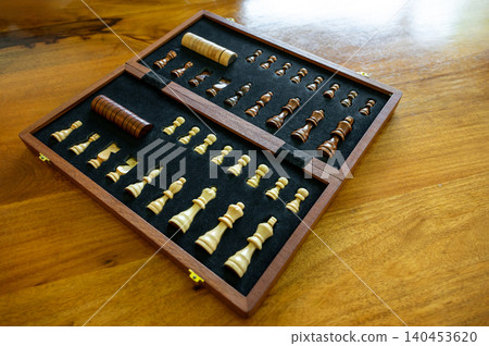 Chess pieces in wooden box on board game table Chess pieces in wooden box on board game table 140453620