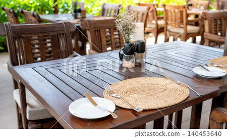 Dining table in outdoor restaurant. Tableware preparation Dining table in outdoor restaurant. Tableware preparation 140453640