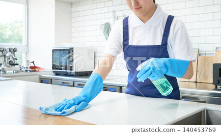 The hands of a female staff member cleaning the kitchen The hands of a female staff member cleaning the kitchen 140453769