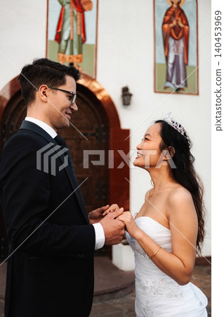 Bride and groom holding hands and smiling on their wedding day Bride and groom holding hands and smiling on their wedding day 140453969