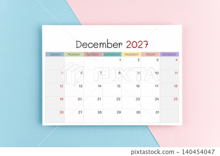 December 2027 calendar page on blue and pink color background. December 2027 calendar page on blue and pink color background. 140454047