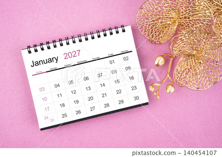 January 2027 desk calendar with golden orchid on pink color background. January 2027 desk calendar with golden orchid on pink color background. 140454107
