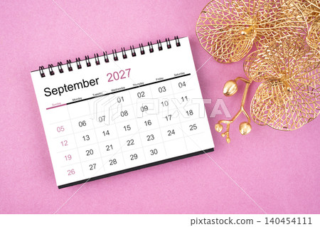September 2027 desk calendar with golden orchid on pink color background. 140454111