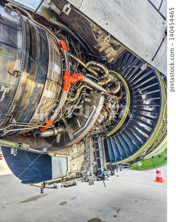 Detailed view of jet engine hardware, pipes, and wiring with open nacelle doors. Professional aerospace engineering and aviation maintenance photo.. High quality photo Detailed view of jet engine hardware, pipes, and wiring with open nacelle doors. Professional aerospace engineering and aviation maintenance photo.. High quality photo 140454465