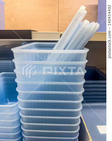 Stacked Light Blue Translucent Plastic Storage Containers with Lids on Store Shelf for Home and Kitchen Organization Stacked Light Blue Translucent Plastic Storage Containers with Lids on Store Shelf for Home and Kitchen Organization 140454492