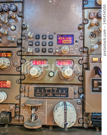 Close-up of Vintage Aircraft Cockpit Avionics Panel with Transponder, ILS Navigation, Rudder Trim Controls, Industrial Aviation Close-up of Vintage Aircraft Cockpit Avionics Panel with Transponder, ILS Navigation, Rudder Trim Controls, Industrial Aviation 140454500