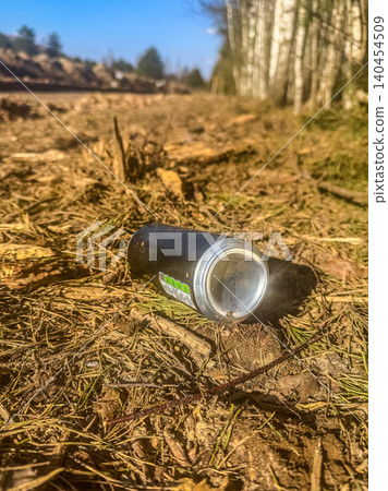Discarded aluminum can in forest litter pollution environmental problem trash in nature close up Discarded aluminum can in forest litter pollution environmental problem trash in nature close up 140454509