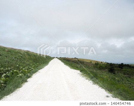 A white road on the Soya Hills under a light cloud cover A white road on the Soya Hills under a light cloud cover 140454746